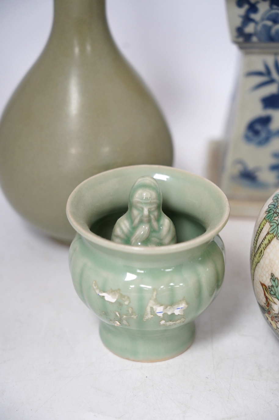Chinese ceramics - a Celadon glazed vase, two jars and covers, a blue and white candlestick and a celadon pot, tallest 29cm (5). Condition - fair to good